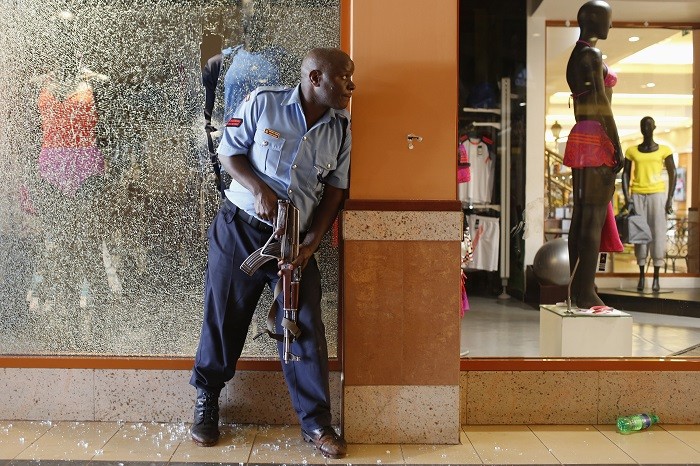 A police officer tries to secure an area inside the Westgate Shopping Centre where gunmen went on a shooting spree in Nairobi September 21, 2013