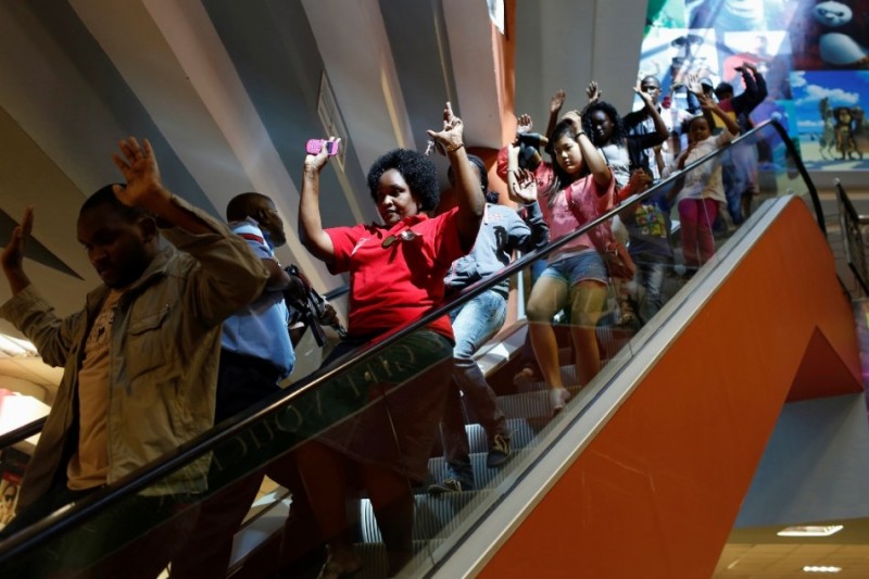 Civilians escape an area at the Westgate Shopping Centre in Nairobi September 21, 2013. 