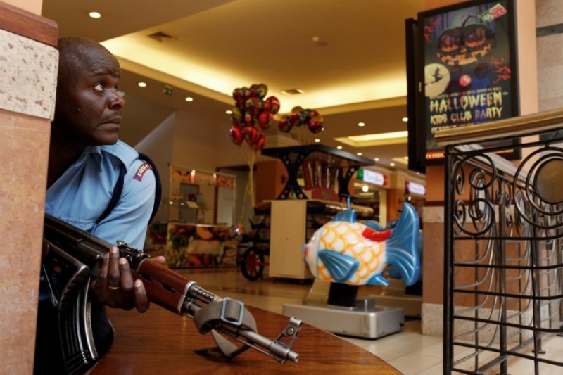 A police officer tries to secure an area inside the Westgate Shopping Centre where gunmen went on a shooting spree in Nairobi September 21, 2013. 