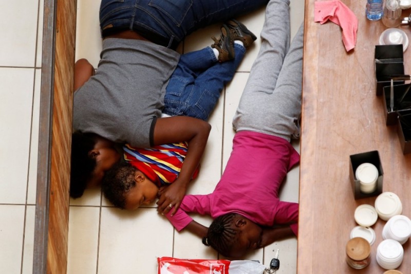 A mother and her children hide from gunmen at Westgate Shopping Centre in Nairobi September 21, 2013.