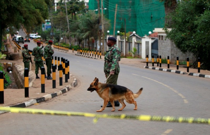 A policeman patrols with his dog near the Westgate Shopping Centre in Kenya's capital Nairobi September 22, 2013.
